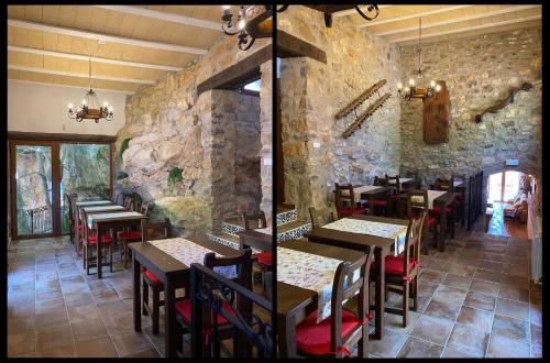 a restaurant with tables and chairs and a stone wall at La Cueva de Miravet - villa de lujo en la cima de la montaña con vistas al mar in Cabanes