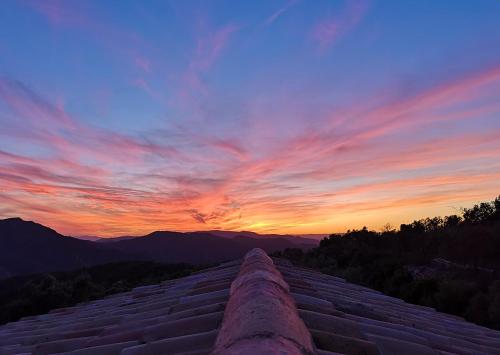 a view from the top of a building at sunset at La Cueva de Miravet - villa de lujo en la cima de la montaña con vistas al mar in Cabanes