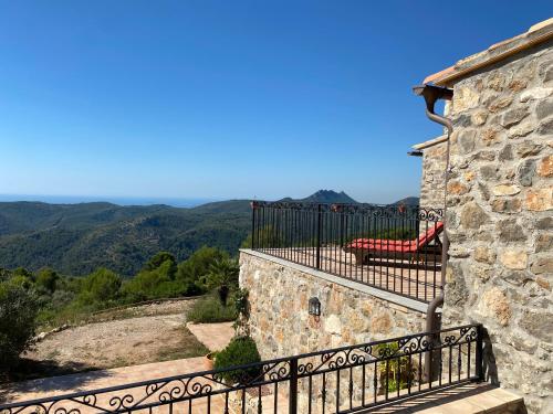 a balcony with a bench on the side of a building at La Cueva de Miravet - villa de lujo en la cima de la montaña con vistas al mar in Cabanes