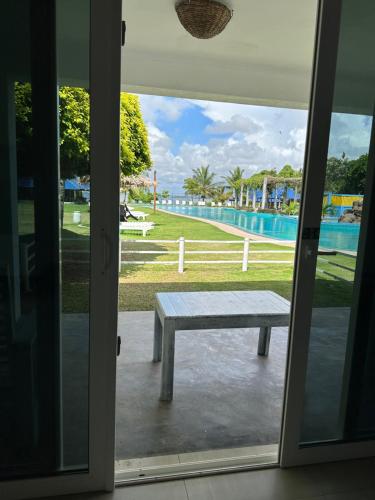a bench outside a door with a view of a pool at Amaluna Resorts in Negombo