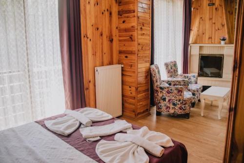 a bedroom with a bed with towels on it at Ayisigi Hotel in Ağva