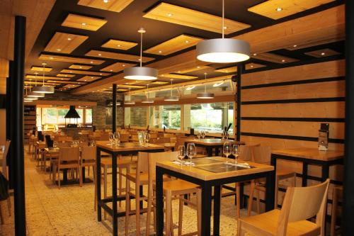 a dining room with wooden tables and chairs at La Pierre à Catillon in Moleson