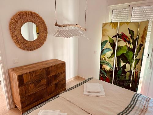 a bedroom with a dresser and a mirror at Modernes Ferienappartement (9-1F) in Manilva