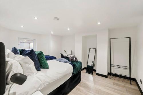 a bedroom with a bed and two mirrors at Stunning Yorkshire Gem - Sleeps 4 in Castleford