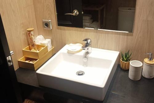 a bathroom with a white sink and a mirror at Apartament a L’Estartit x 4 in Torroella de Montgrí