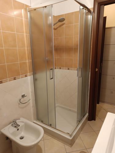 a shower in a bathroom with a sink and a toilet at Dario's house in Sassari