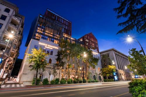 a city street at night with tall buildings at Tbilisi Philharmonic Hotel by Mercure in Tbilisi City