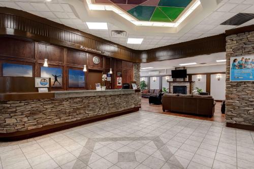 a lobby with a stone bar in a hotel at Days Inn by Wyndham Calgary South in Calgary