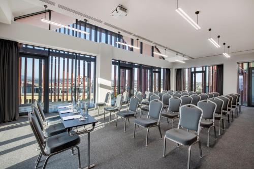a conference room with chairs and tables and windows at Tbilisi Philharmonic Hotel by Mercure in Tbilisi City