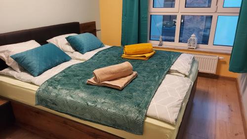 a bed with two pillows on top of it at Apartament Kallisto in Bydgoszcz