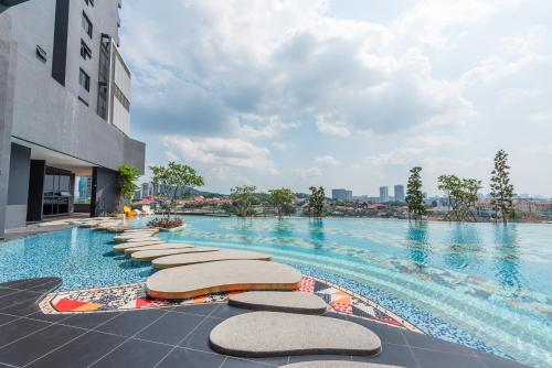 a swimming pool with chaise lounges in a building at Arte Cheras by Minsu in Kuala Lumpur