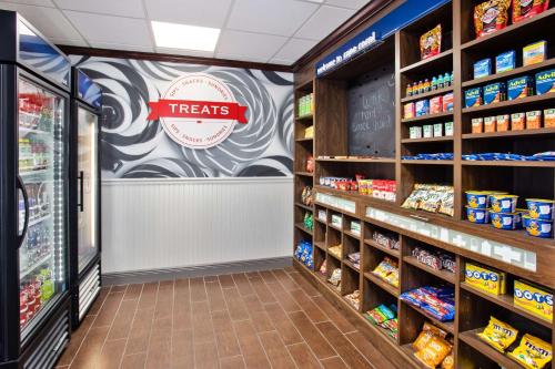 a grocery store aisle with a treats sign on the wall at Hampton Inn & Suites Cape Coral / Fort Myers in Cape Coral