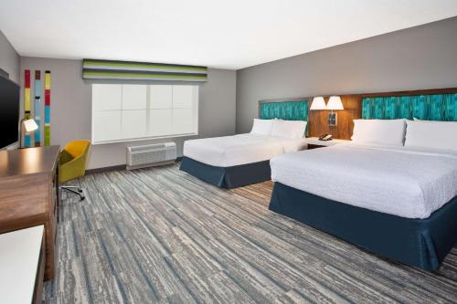 a hotel room with two beds and a desk at Hampton Inn & Suites Cape Coral / Fort Myers in Cape Coral