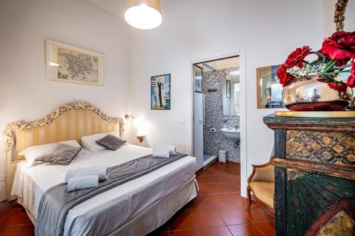 a bedroom with a bed and a bathroom at Roommo Cimabue in Florence