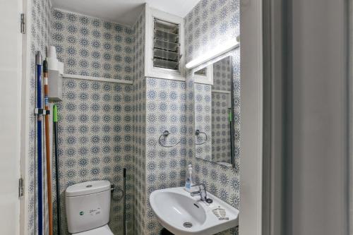a small bathroom with a toilet and a sink at 1a Linea mar port Llafranch in Llafranc