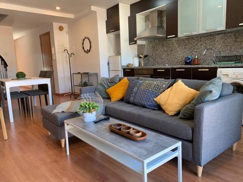 a living room with a couch and a table at ApartaMonti Dúplex in Montesquíu
