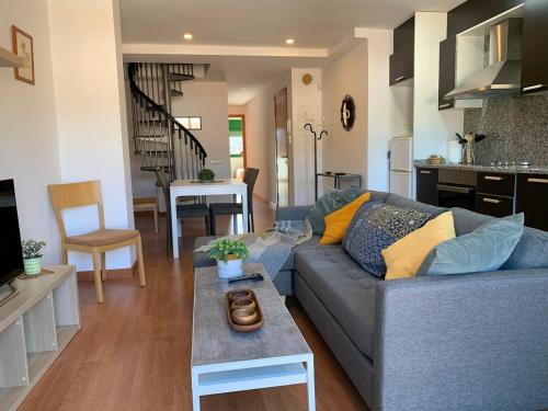 a living room with a couch and a table at ApartaMonti Dúplex in Montesquíu