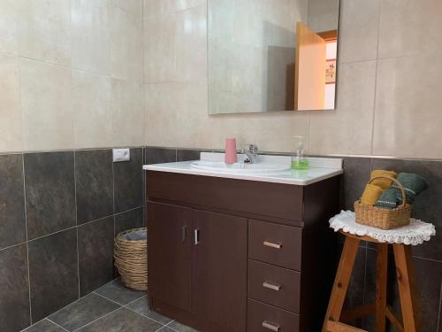 a bathroom with a sink and a mirror at ApartaMonti Dúplex in Montesquíu