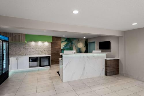 a large kitchen with white appliances and green accents at Wyndham Garden Ankeny in Ankeny