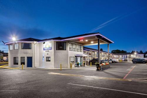 a parking lot in front of a building at Days Inn by Wyndham Lakewood South Tacoma in Lakewood