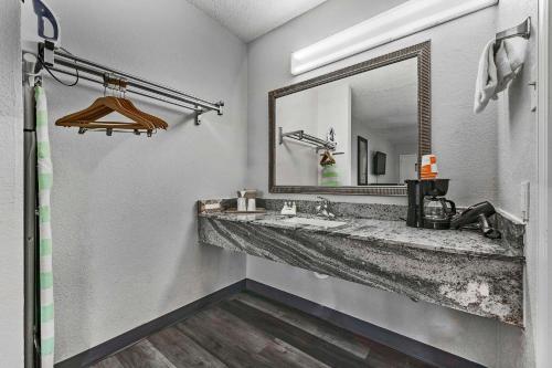 a bathroom with a sink and a mirror at Quality Inn in Fayetteville