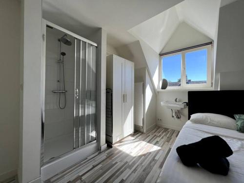 a bedroom with a shower and a bed and a sink at Cozy Private Room 5 on a Busy Persian Restaurant in Eindhoven