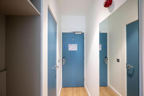 a row of blue doors in a hallway at University of Galway Rooms in Galway