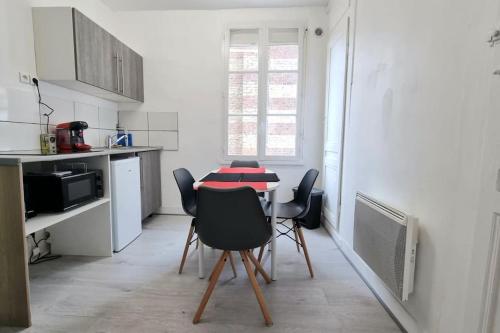 une cuisine avec une table et des chaises dans une pièce dans l'établissement Chez K&D T2 Rouge Le Havre, au Havre