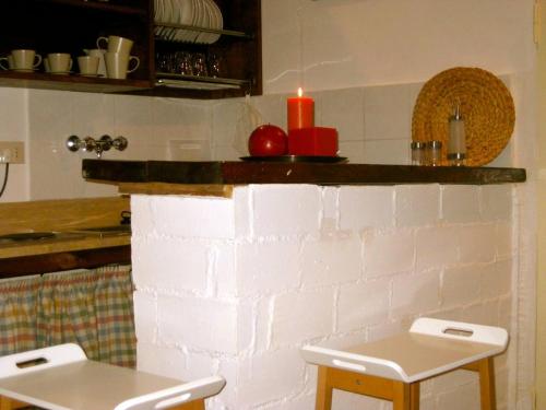 a kitchen with a candle on a brick wall at Casina Roma, 2 min to Piazza Navona in Rome