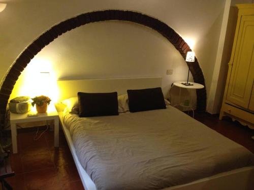 a bedroom with a large bed with an arch above it at Casina Roma, 2 min to Piazza Navona in Rome