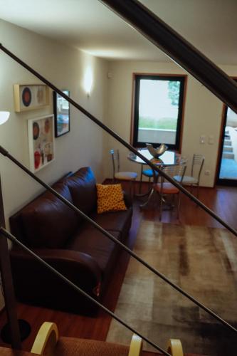 a living room with a couch and a television at ROTA - Opo airport house in Maia