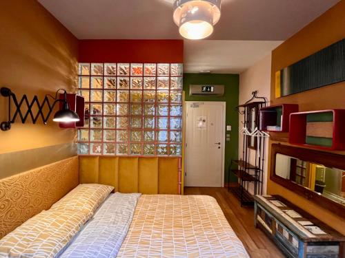 a bedroom with a bed and a large window at MuziKafe - Home of Culture in Ptuj