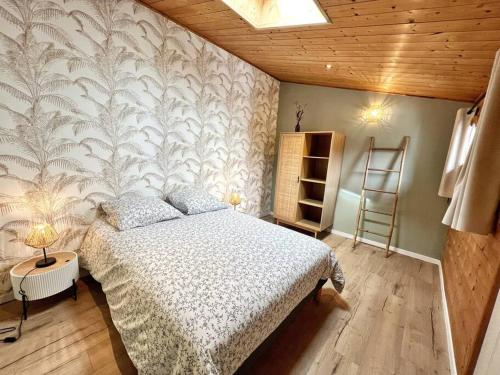 a bedroom with a bed and a wall mural at L'évasion - Terrasse privée in La Rochelle