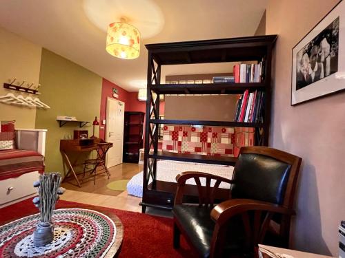 a living room with a bunk bed and a chair at MuziKafe - Home of Culture in Ptuj