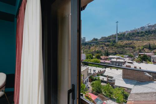 a window with a view of a city at About Sololaki in Tbilisi City