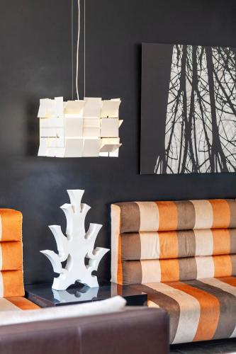 a living room with a table and a chandelier at H10 Roma Città in Rome