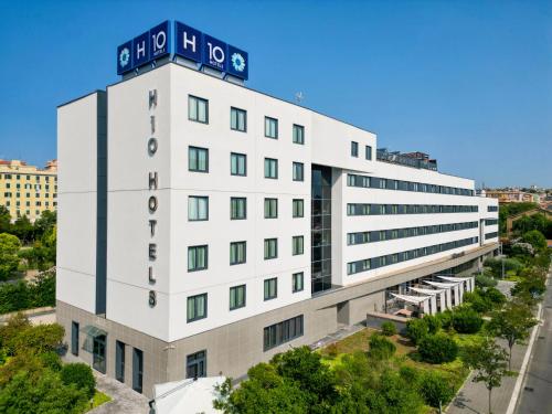 an office building with a sign on top at H10 Roma Città in Rome