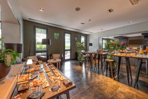 a restaurant with a buffet of food on tables at H10 Roma Città in Rome