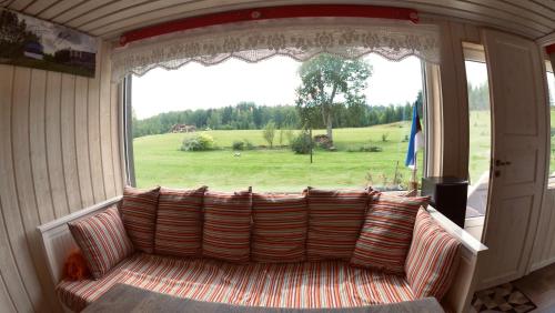 a couch in a room with a large window at Ala Sarise saunamaja in Sarise