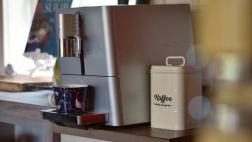 a coffee maker and a cup on a table at Ala Sarise saunamaja in Sarise