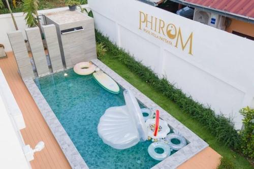 a miniature pool with a surfboard and a toy boat at Phirom pool villa pattaya in Nong Prue