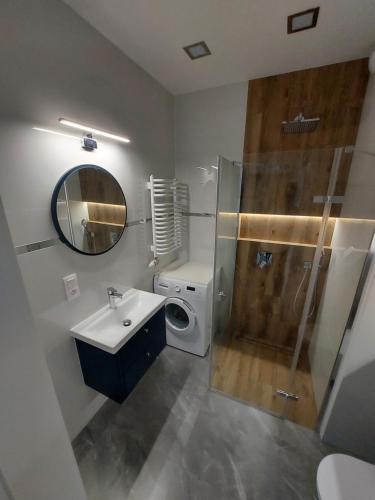 a bathroom with a sink and a shower and a toilet at Katowice Sokolska Towers in Katowice