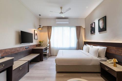 a hotel room with a bed and a desk at City Connect by Downtown Udaipur in Udaipur