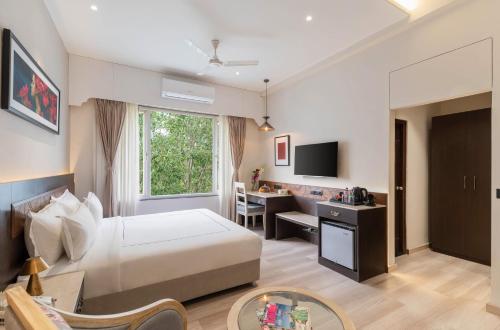 a hotel room with a bed and a desk at City Connect by Downtown Udaipur in Udaipur