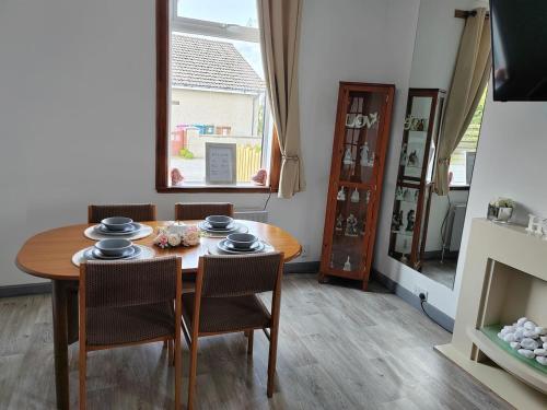 a dining room with a table and chairs and a window at Westview in Buckie