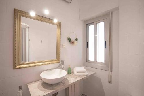 a white bathroom with a sink and a mirror at LC Apartaments Av del Mar in Castellón de la Plana