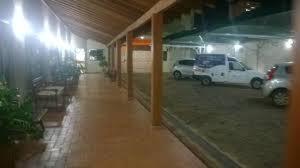 a building with cars parked in a parking lot at Ville Park Hotel in Ourinhos
