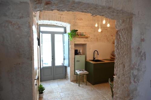 a kitchen with a green refrigerator and a window at La Casetta in Alberobello