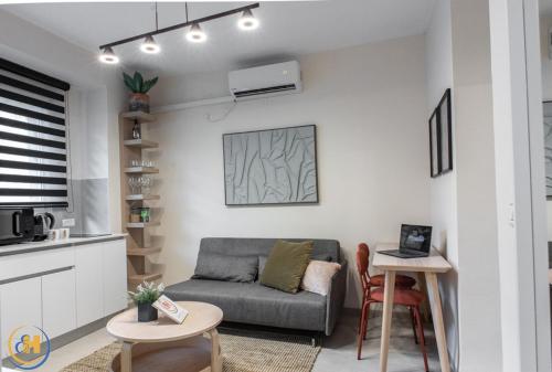 a living room with a couch and a table at Eshkol Housing Haifa-Disraeli Urban & Business boutique Apartments complex in Haifa