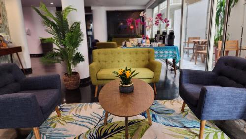 a lobby with chairs and a table with flowers on it at Stay Hotel Waikiki in Honolulu